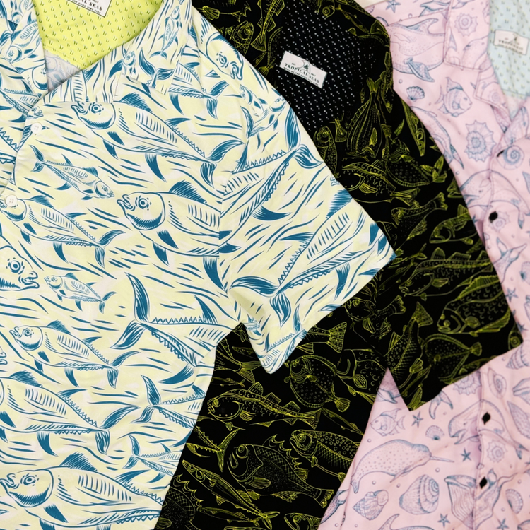 Three shirts from the Performance Luxury Resortwear Collection by Tropical Seas Clothing, featuring marine life patterns in blue, black, and pink. Ideal for a sophisticated, tropical-inspired look.