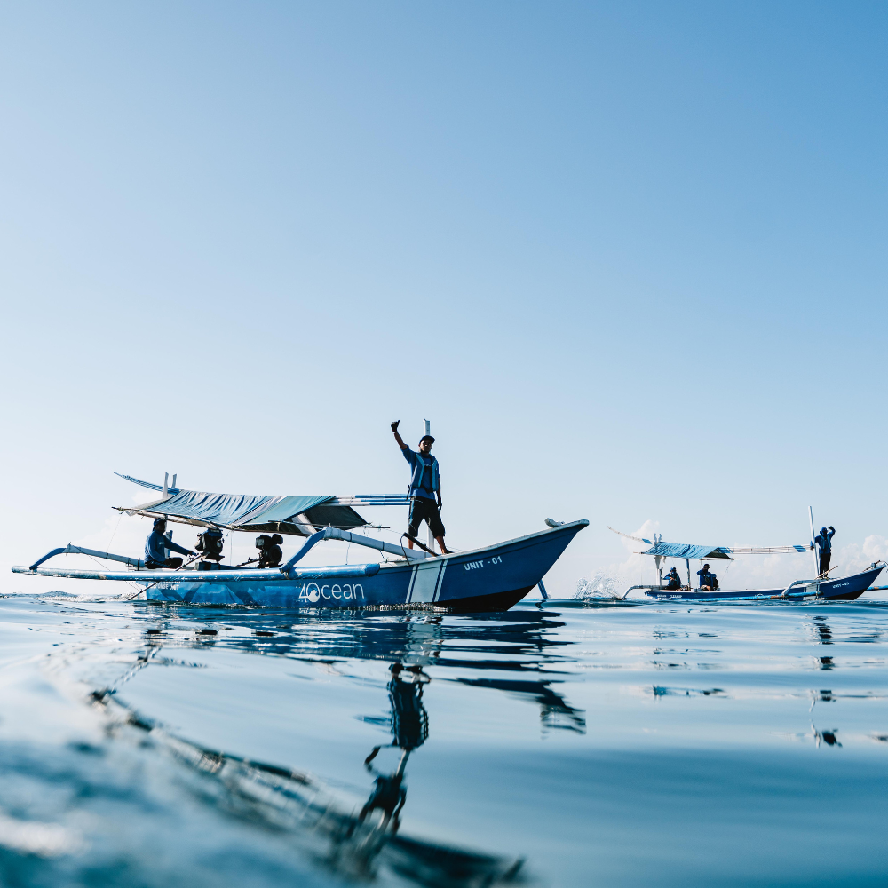 Image showing Volunteers from Tropical Seas Clothing and 4Ocean removing plastic waste from the ocean.