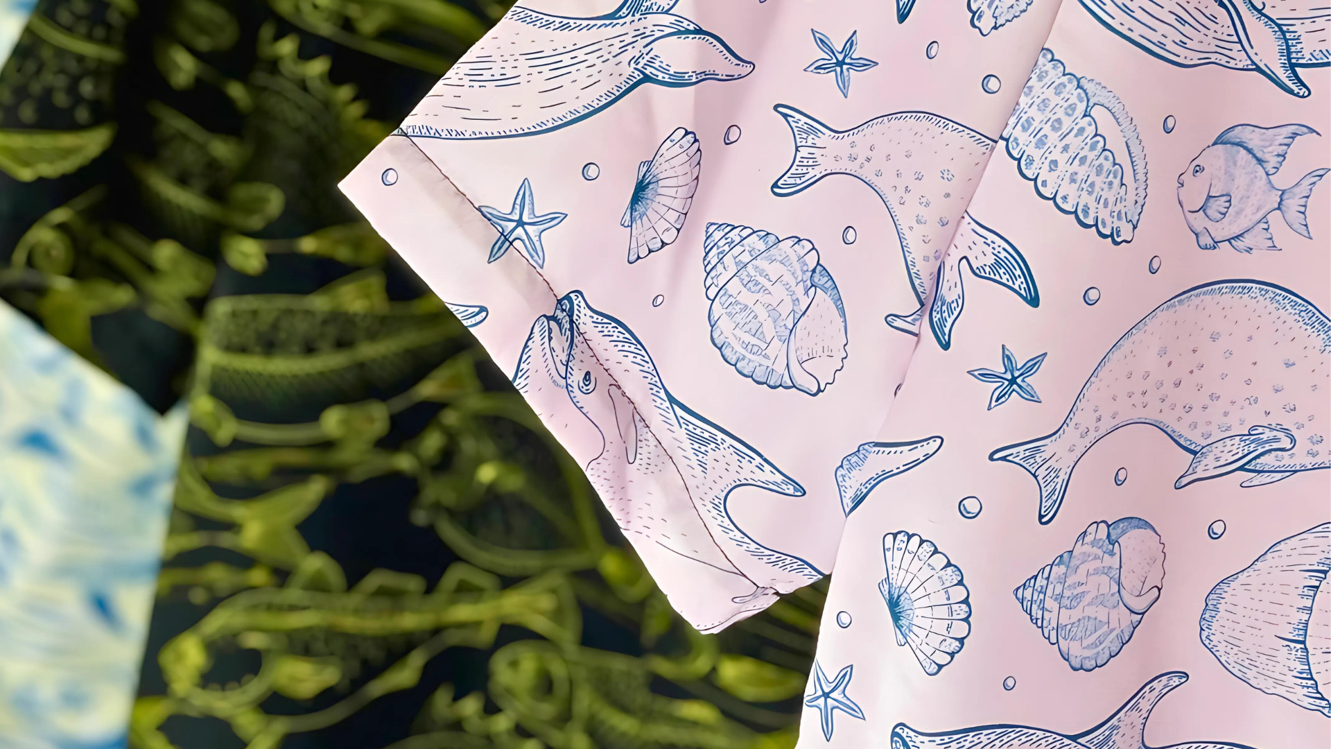 Sustainable pink beachwear with blue ocean-inspired whale and seashell print, perfect for eco-conscious vacationers and resort fashion.